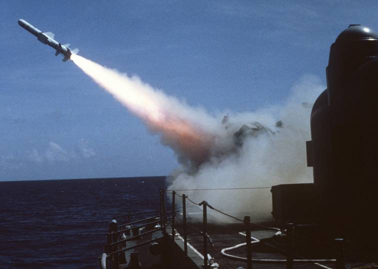 Charles F. Adams class DDG fires a Harpoon SSM from her Mk-11 missile launcher